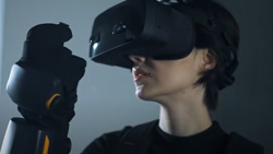 A closeup of a person wearing HaptX Gloves G1 and VR goggles