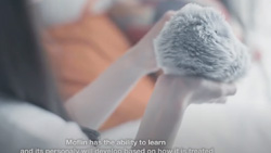 A view from behind a person holding a hand-sized robot covered in fur