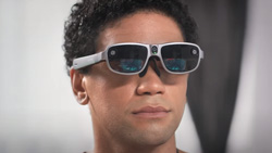 A closeup of a man wearing AR glasses.