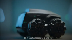 a blurred closeup of a small compact four-wheeled robot with knobby tires