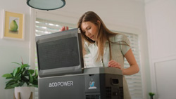 A person opens a gray cooler on a kitchen countertop