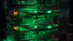 A closeup of a mini computer with glowing green LEDs.