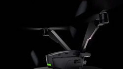 A closeup darkened view of a carbon-colored dual rotor drone.