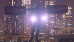 A night time scene shows a person flying a backpack copter in front of a cityscape.