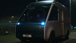a white and black electric van on the road at night
