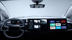 A closeup view of an electric vehicle dashboard shows an interactive display across the entire length.