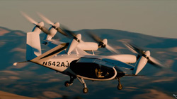 a closeup up of a white aircraft in flight with 6 drone like propellers attached to a horizontal tear-drop shaped cabin