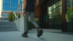 A person walking towards stairs in motorized attachments for shoes