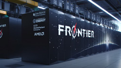 A view of a row of black supercomputer cabinets with the word Frontier on the front