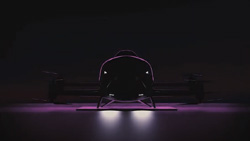 The darkened image of an evtol on the ground front view with white and violet LED landing lights