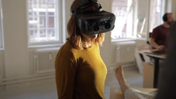 a person is wearing a VR headset and is looking down at a patient