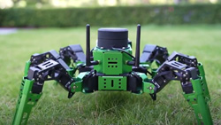 A green hexapod robot with a LIDAR puck on top.