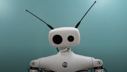 A white humanoid shaped robot is shown from the shoulders up. It has a horizontal capsule shaped head with one large black eye and one small eye (possibly cameras). It has two long black antennas on each side.