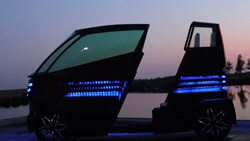 A view at dusk at a water's edge of a backlit vehicle with blue LED trim that has a gap in the middle