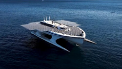 A white catamaran-style ship with flat solar panels covering the top and extending out the sides.