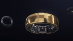 A gold ring with electronics visible on the inside part of the ring