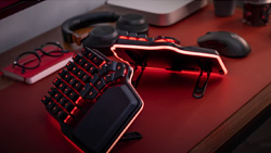 A black, split keyboard with red LED lights underneath. They are set at a 45 degree angle and have wrist rests attached.