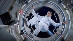 A person is floating in space inside a spacecraft.