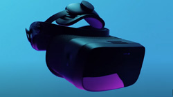 A view of a black virtual reality headset floating in the air with a light blue background.
